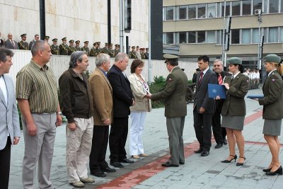 Handing the thank-you certificates to civilian employees